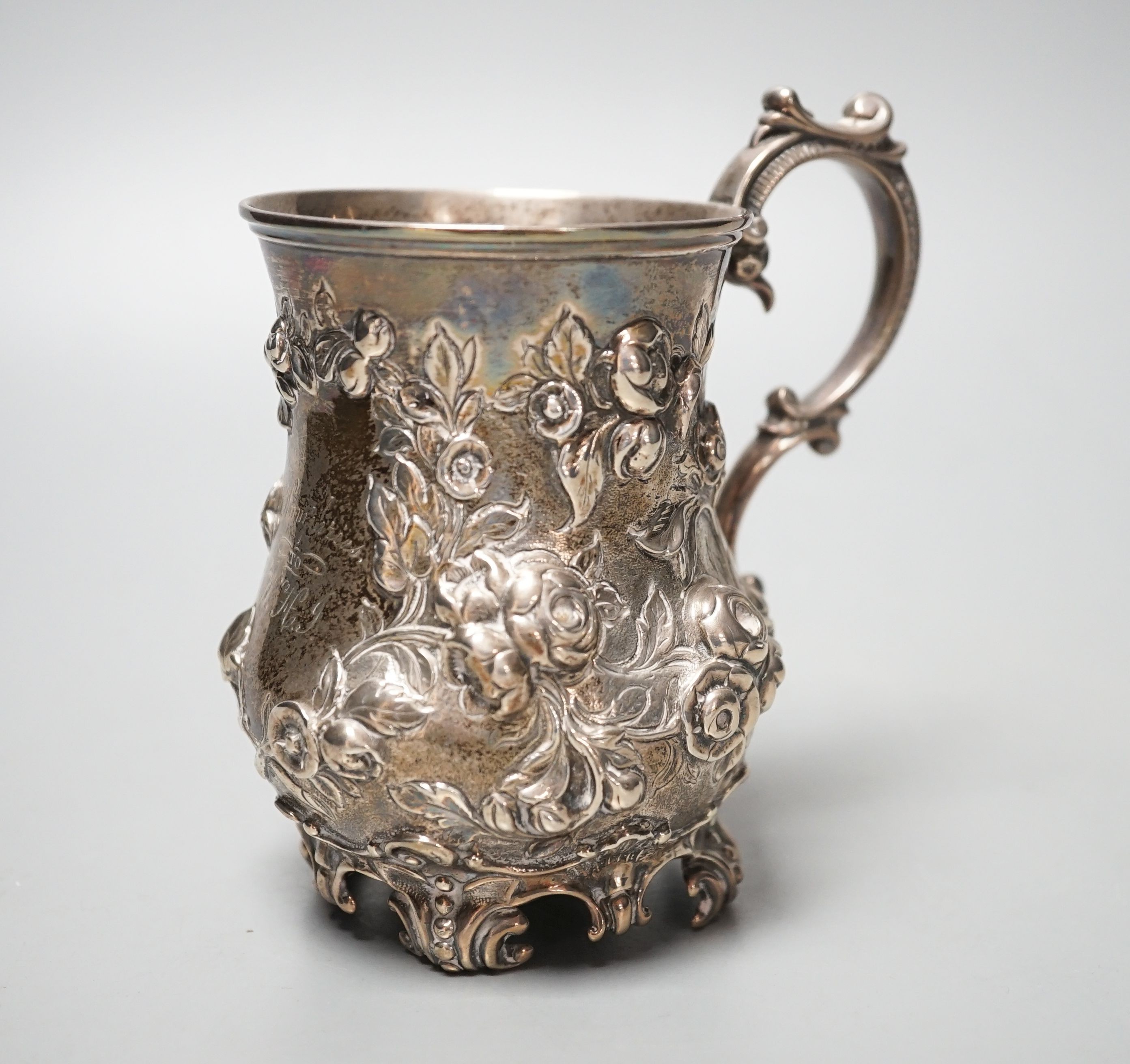 A Victorian embossed silver christening mug, Martin, Hall & Co, Sheffield, 1866, with engraved inscription, 12cm, 8oz.